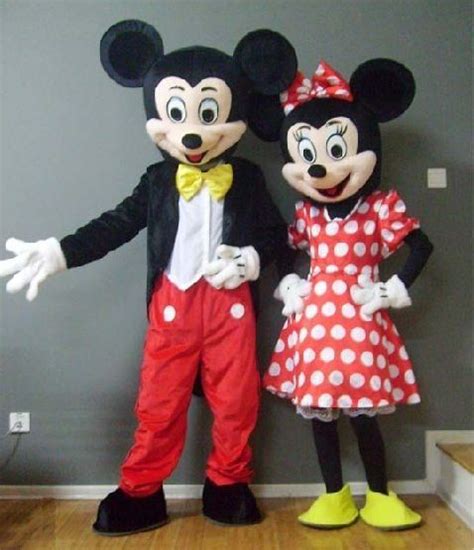 Two Mickey And Minnie Mouse Mascot Standing Next To Each Other On A