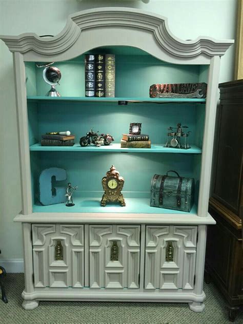 A White China Cabinet With Many Items On It