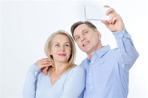 Premium Photo Happy Middle Aged Couple Taking Selfie With Smartphone