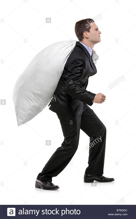 Full Length Portrait Of A Businessman Carrying A Money Bag Stock Photo