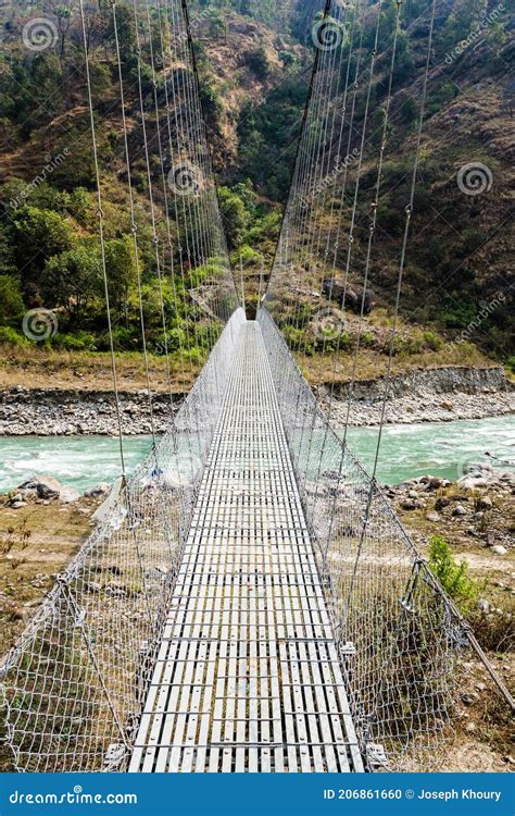 Long Suspension Bridge In Rural Nepal Annapurna Circuit Stock Photo