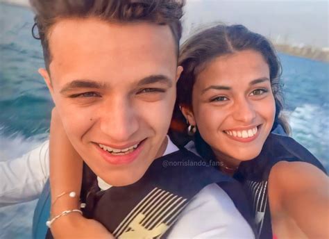 A Man And Woman Smiling While Riding On A Boat In The Ocean With Their