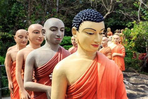 Statues Of Buddhist Monks Standing In Line To Worship The Buddha