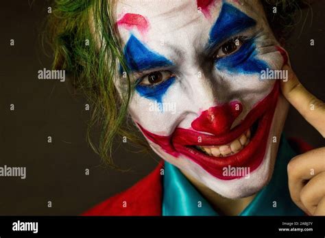 Man Impersonating The Joker Portrait Of A Smiling Man With Clown