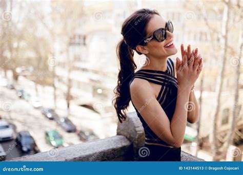 A Beautiful Brunette In Black Sunglasses And Dress Hair Ponytail