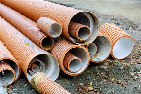 Plastic Pvc Pipes Stacked In Rows At A Construction Site On