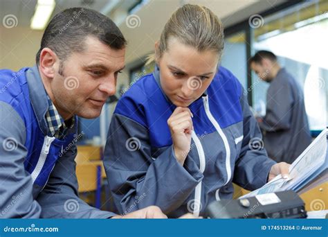 Engineers Looking At Machine Stock Photo Image Of Teamwork Business