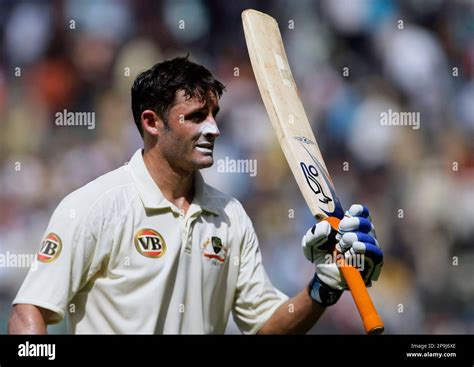 Australian Cricket Player Mike Hussey Left Raises His Bat To