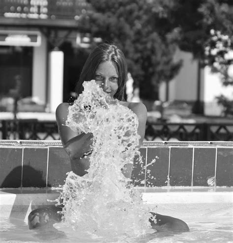 Premium Photo Portrait Of Sensuous Woman Splashing Water In Swimming Pool