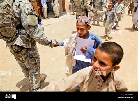 Afghan Boys Shake Hands With Soldiers After A Ribbon Cutting Ceremony