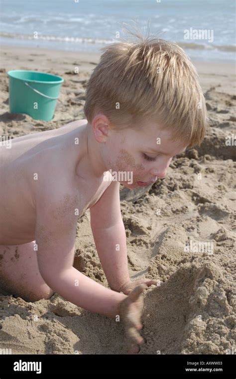 Boy Building Sand Castle On Beach Stock Photo Alamy