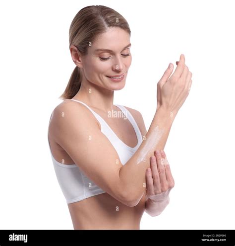 Woman Applying Body Cream Onto Her Arm Against White Background Stock