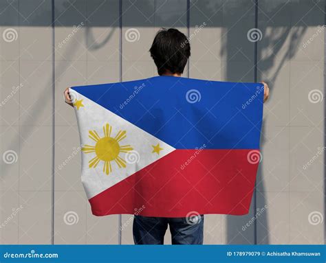 The Man Holding Philippines Flag On His Shoulder And Turn Back On Grey