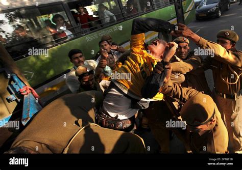 A Tibetan Activist Shouts Slogans As He Is Lifted By Indian Policemen