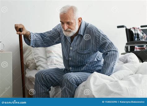 Sad Senior Man With Alzheimer S Disease Holding Walking Stick And