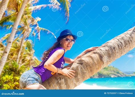 Young Beautiful Asian Girl On The Palm Tree On A Tropical Beach Stock