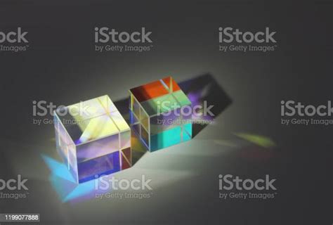 Two Cube Glass Prism Refract Light Into Different Colors And Cast