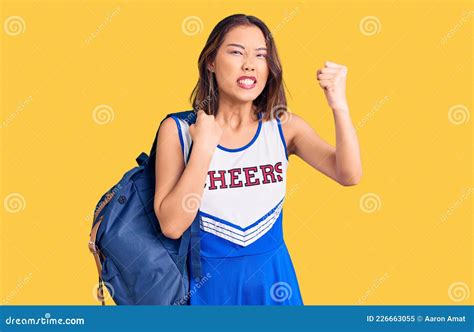 Young Beautiful Chinese Girl Wearing Cheerleader Uniform Holding