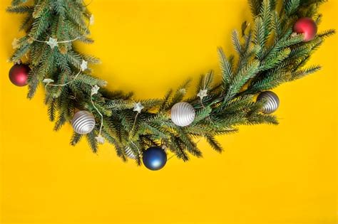 Premium Photo | Christmas wreath on yellow