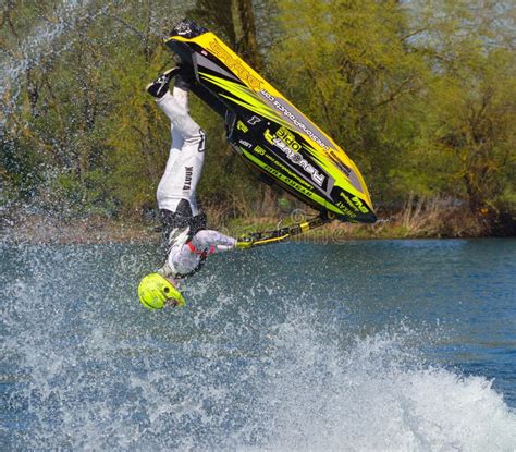 Freestyle Jet Skier Competitor Performing Back Flip Creating At Lot Of