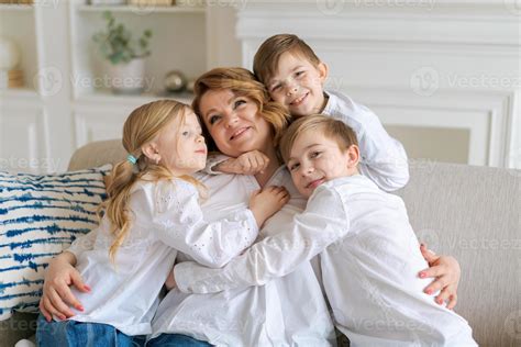 Cute kids hugging, excited mom showing love and affection, smiling