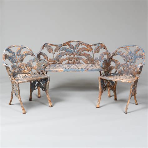 At Auction Diminutive Suite Of Painted Cast Iron Fern Pattern Garden Seats