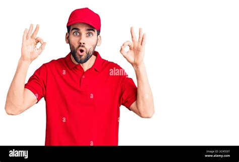 Young Handsome Man With Beard Wearing Delivery Uniform Looking