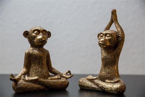 Closeup Shot of a Gold Monkey Statue on a Wooden Surface Stock Photo ...