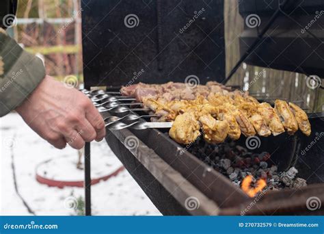 A Man Flips A Meat Kebab On The Grill Barbecue Stock Image Image Of