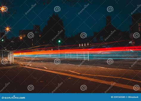 Long Exposure Of Light Trails Captured In A Road Surrounded By Street