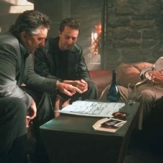 Three Men In Suits Sitting Around A Table