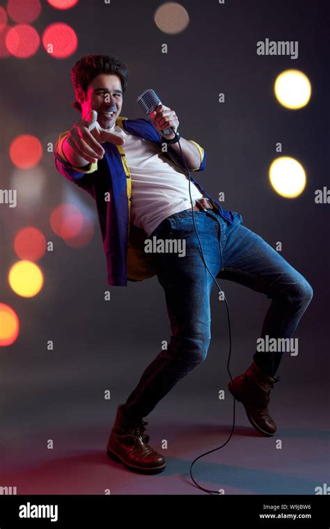 Man Singing Into Microphone And Dancing Stock Photo Alamy