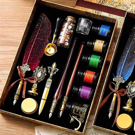 An Open Box Containing Several Different Types Of Pens And Quill Sets