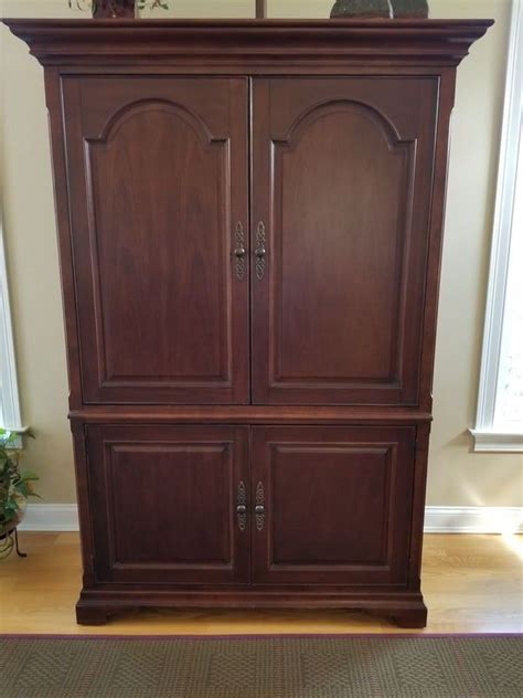 Hardwood Armoire Cabinet By Bassett Furniture Ellway Collection With Built In Outlets Cabinet