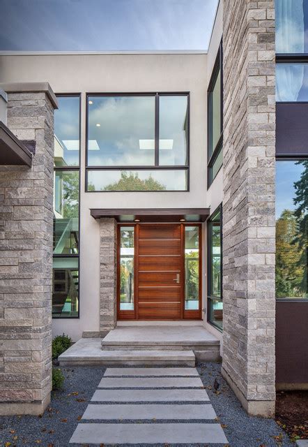 Entry Featuring Stone Stucco And Glass With Mahogany Front Door With