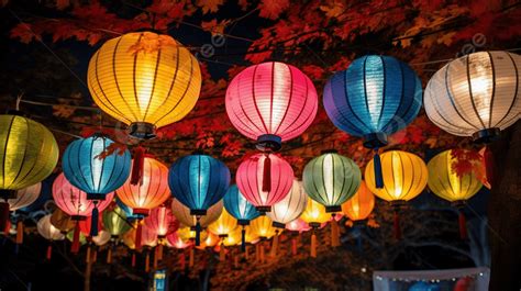 Numerous Colorful Paper Lanterns Hung Along A Tree Background Colorful