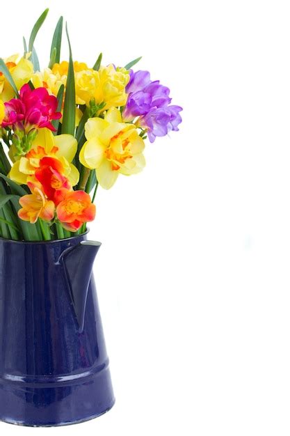 Premium Photo Blue And Yellow Freesia And Daffodil Flowers In Blue