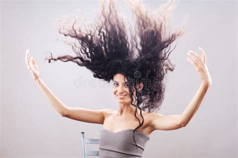 Beautiful Brunette Girl With Long Curly Hair In The Air Studio Portrait Happy Smiling Face