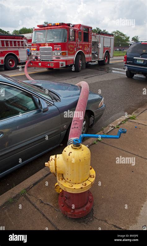 Detroit Michigan A Fire Hose Is Draped Over An Illegally Parked Car