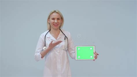 Portrait Of A Female Doctor With White Coat And Tablet With Green