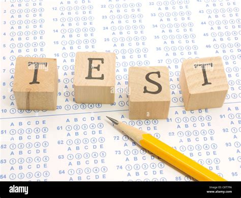 Wooden Blocks Spell Out Test On A Blue Bubble Or Scantron Sheet With A