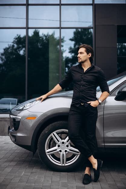 Premium Photo Handsome Man Standing By His New Car