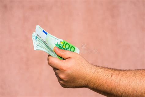 Hand Holding Showing Euro Money Or Giving Money Like Bribe Or Tips 100