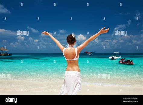Woman In Bikini At Tropical Beach Seaplane At Background Stock Photo