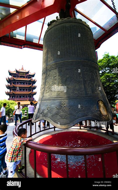 A Big Traditional Chinese Bell And The Yellow Crane Pagoda In The