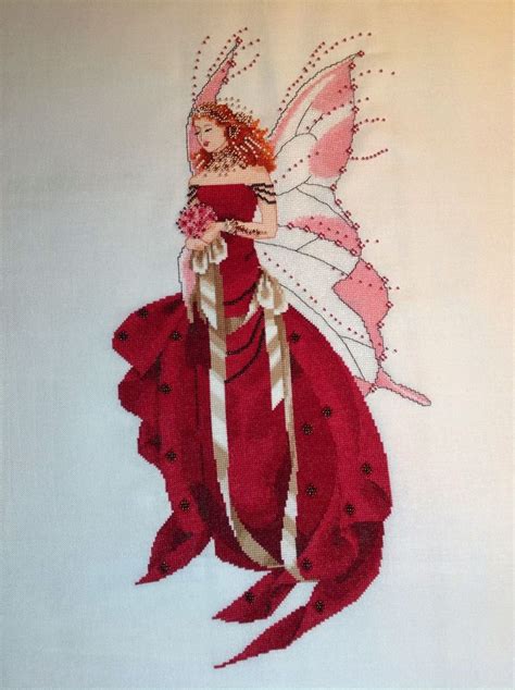 A Red Fairy With White Wings And Pink Dress