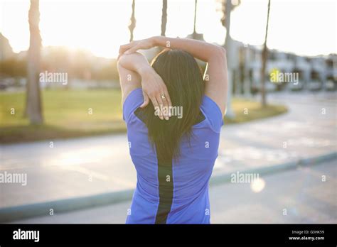 Rear View Of Woman Hand Behind Head Stretching Stock Photo Alamy