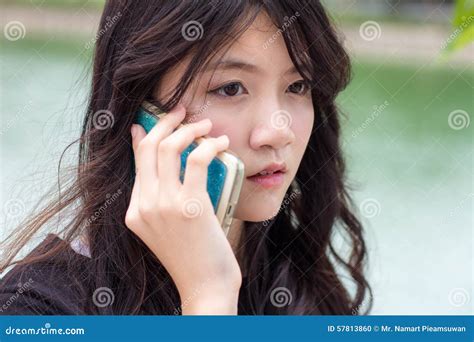 Thai Student Teen Beautiful Girl Answer The Phone And Smile Stock Photo