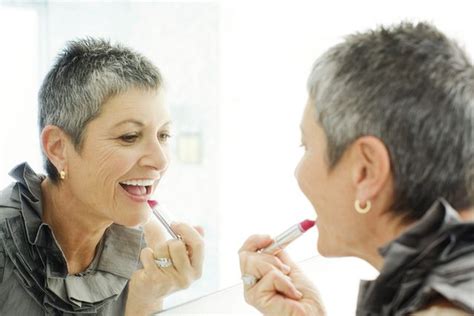 Must Read Makeup Tips For Women Over Older Woman Applying Lipstick