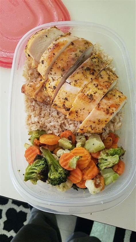 A Plastic Container Filled With Rice Meat And Veggies On Top Of A Table